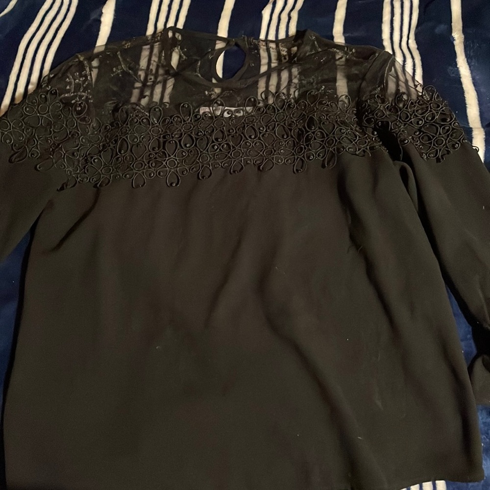 i am selling a blouse with a open back and very top with floral designs